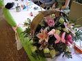 Making in a basket with several flowers in pink colour and accessories
